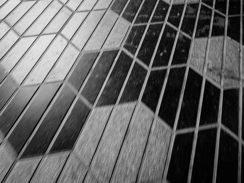 Black and white geometric floor tiles with hexagonal and diamond patterns.
